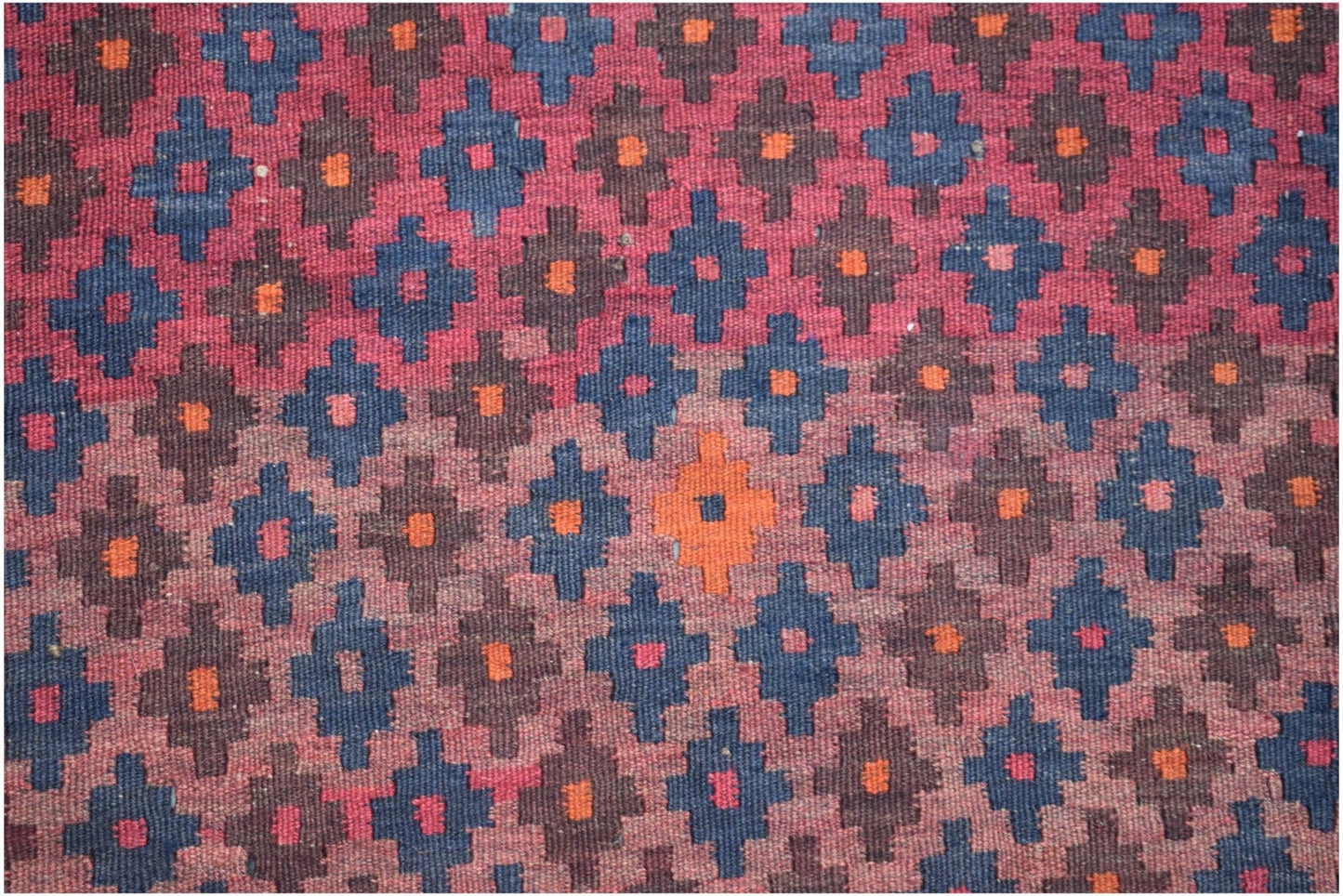 Handmade Afghan Maimana kilim rug featuring a repeating geometric pattern in red, blue, and orange.