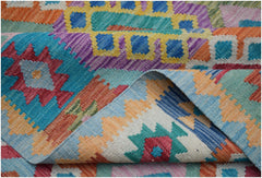 A handwoven Afghan Maimana kilim rug featuring a vibrant geometric pattern in wool.