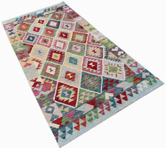 Afghan Maimana Kilim with colorful geometric diamond patterns.