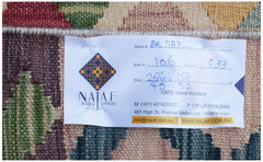 A handwoven Afghan Maimana Kilim featuring a geometric pattern in rich, multicolored wool.
