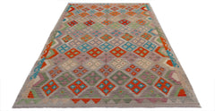 Handwoven Afghan Maimana kilim rug featuring a colorful geometric diamond pattern on a wool base.