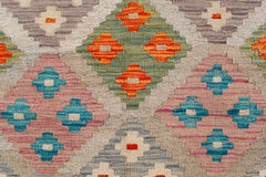 Handwoven Afghan Maimana Kilim featuring a geometric pattern of colorful diamonds on a neutral base.