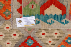 An Afghan Maimana kilim featuring a geometric pattern in vibrant orange, red, and blue tones.