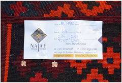 An Afghan Maimana Kilim rug featuring a geometric pattern in red, black, and dark blue.