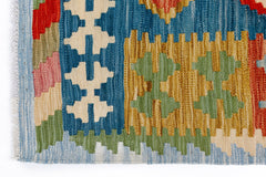 A handmade Afghan Maimana kilim featuring a geometric pattern in blue, yellow, green, and red.
