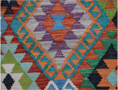 Handwoven Afghan Maimana kilim featuring a vibrant geometric pattern in wool.