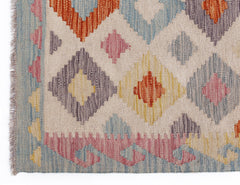 Handwoven Afghan Maimana kilim rug featuring a geometric diamond pattern in multicolored wool.