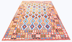 An Afghan Maimana Kilim rug featuring a vibrant geometric diamond pattern on a red background.