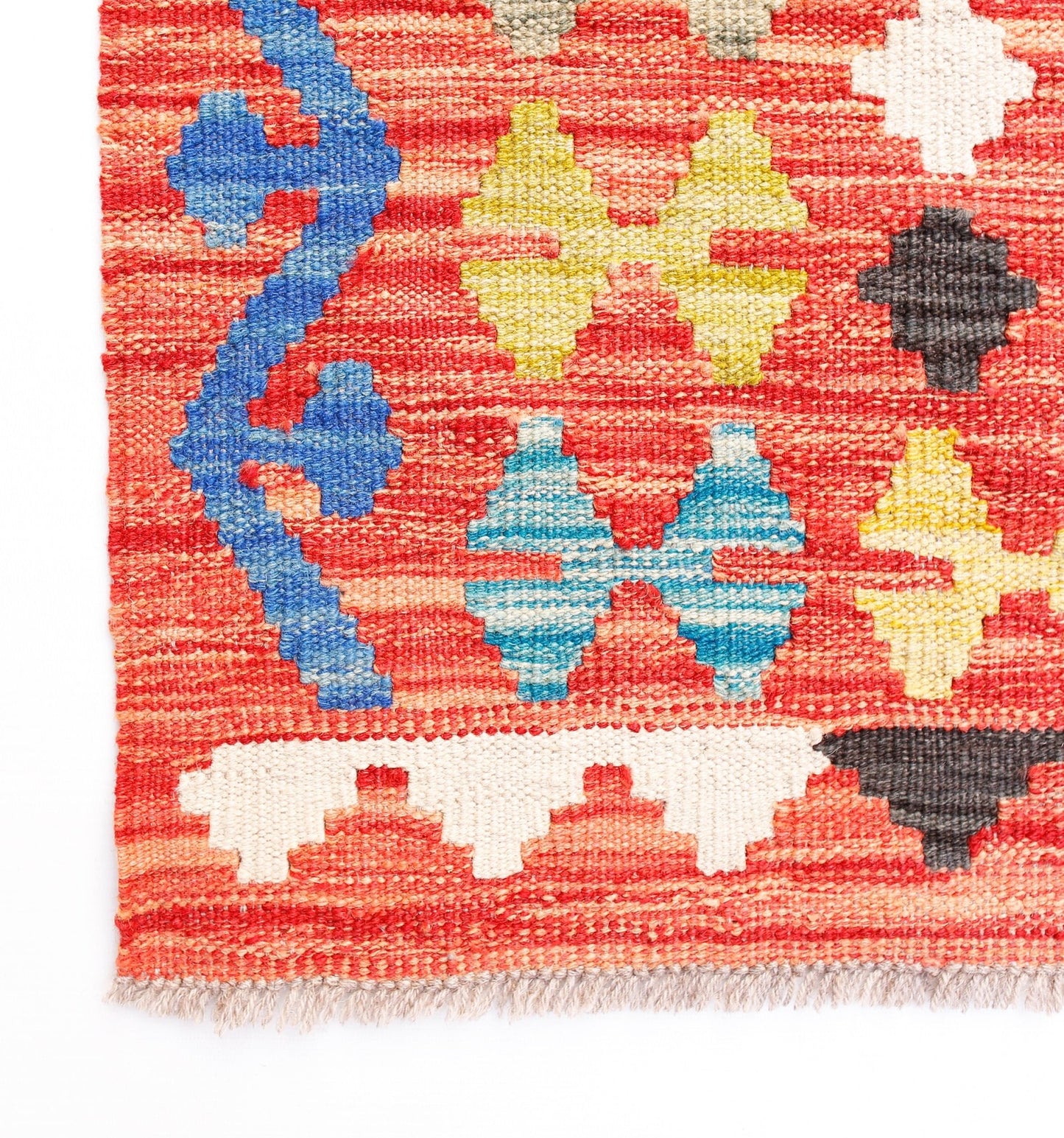 Handwoven Afghan Maimana kilim rug featuring a geometric pattern in red, blue, yellow, and white.