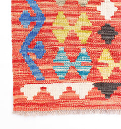 Handwoven Afghan Maimana kilim rug featuring a geometric pattern in red, blue, yellow, and white.
