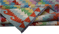 Handwoven Afghan Maimana kilim featuring a colorful geometric pattern in a flatweave wool texture.