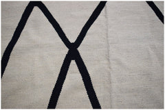 A handmade Afghan Maimana kilim featuring a minimalist black geometric pattern on a cream background.
