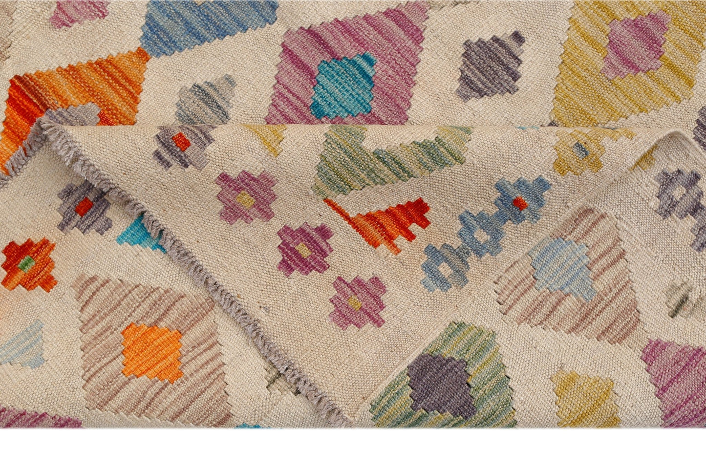 Handwoven Afghan Maimana kilim featuring a geometric pattern in vibrant multicolored wool.