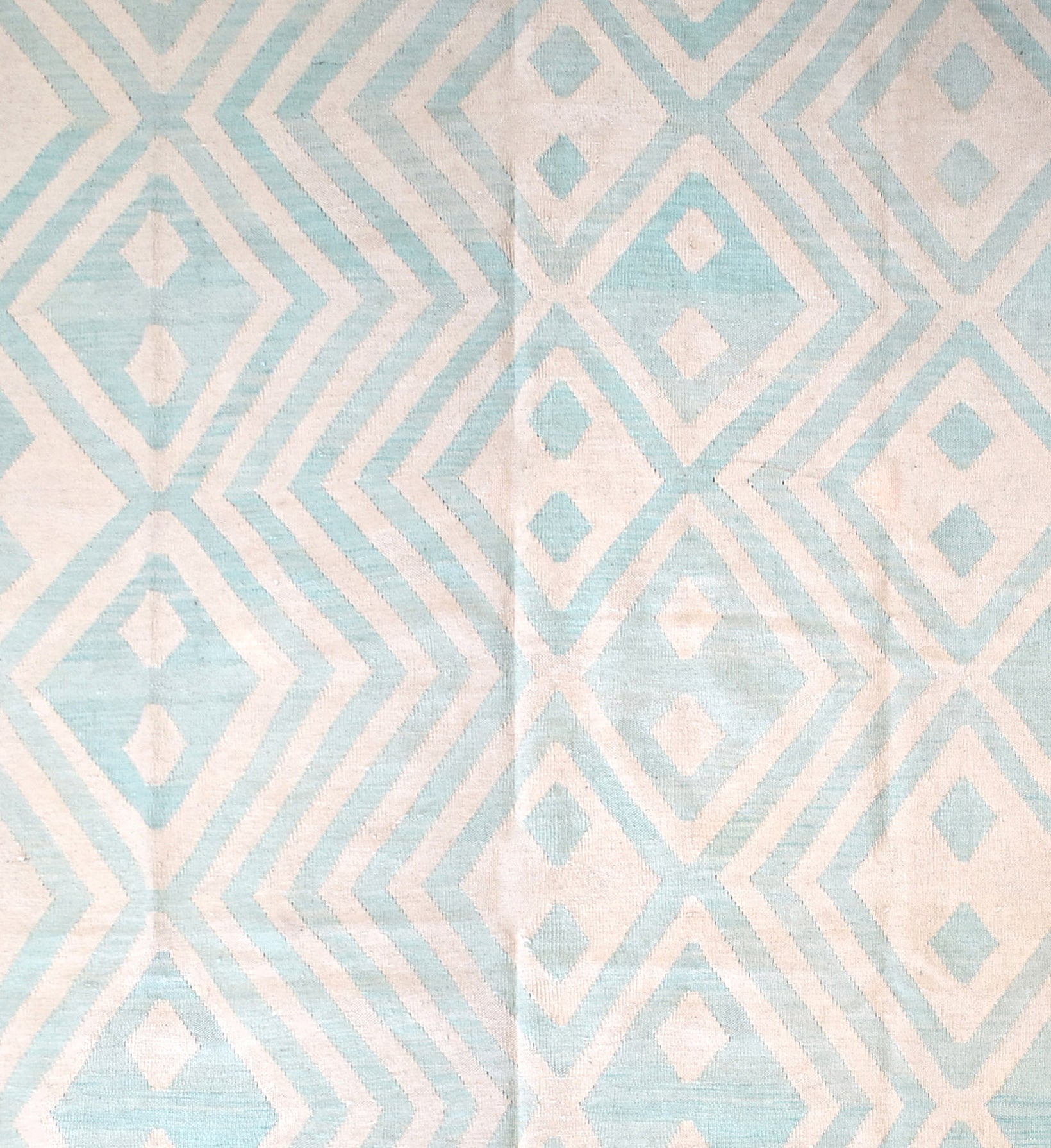 Handmade Afghan Maimana kilim rug featuring a geometric diamond pattern in light blue and cream.