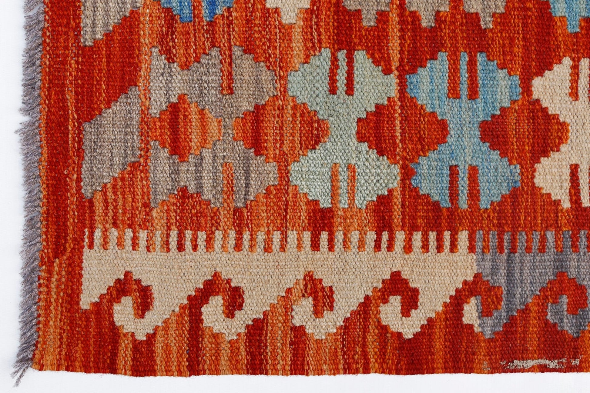 Handwoven Afghan Maimana kilim featuring geometric patterns in orange, blue, and beige wool.