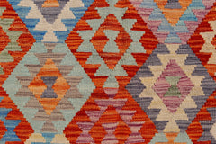 Handwoven Afghan Maimana kilim featuring a vibrant geometric diamond pattern in wool.