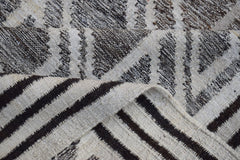 A handmade Afghan Maimana kilim rug featuring a geometric pattern in natural wool.