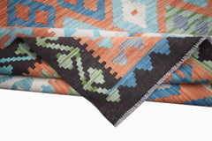 A handmade Afghan Maimana kilim rug featuring a geometric pattern in orange, blue, and black wool.