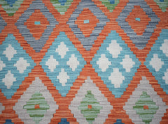 Handwoven Afghan Maimana kilim featuring a vibrant geometric pattern in orange, blue, and green.