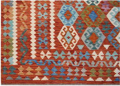 Handwoven Afghan Maimana kilim featuring a geometric pattern in vibrant orange and blue tones.