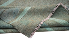 A handmade Afghan Maimana kilim rug featuring a flat-woven texture in shades of green.