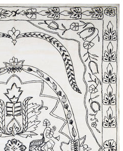 A close-up of a white wool kilim featuring intricate black hand-embroidered floral patterns.