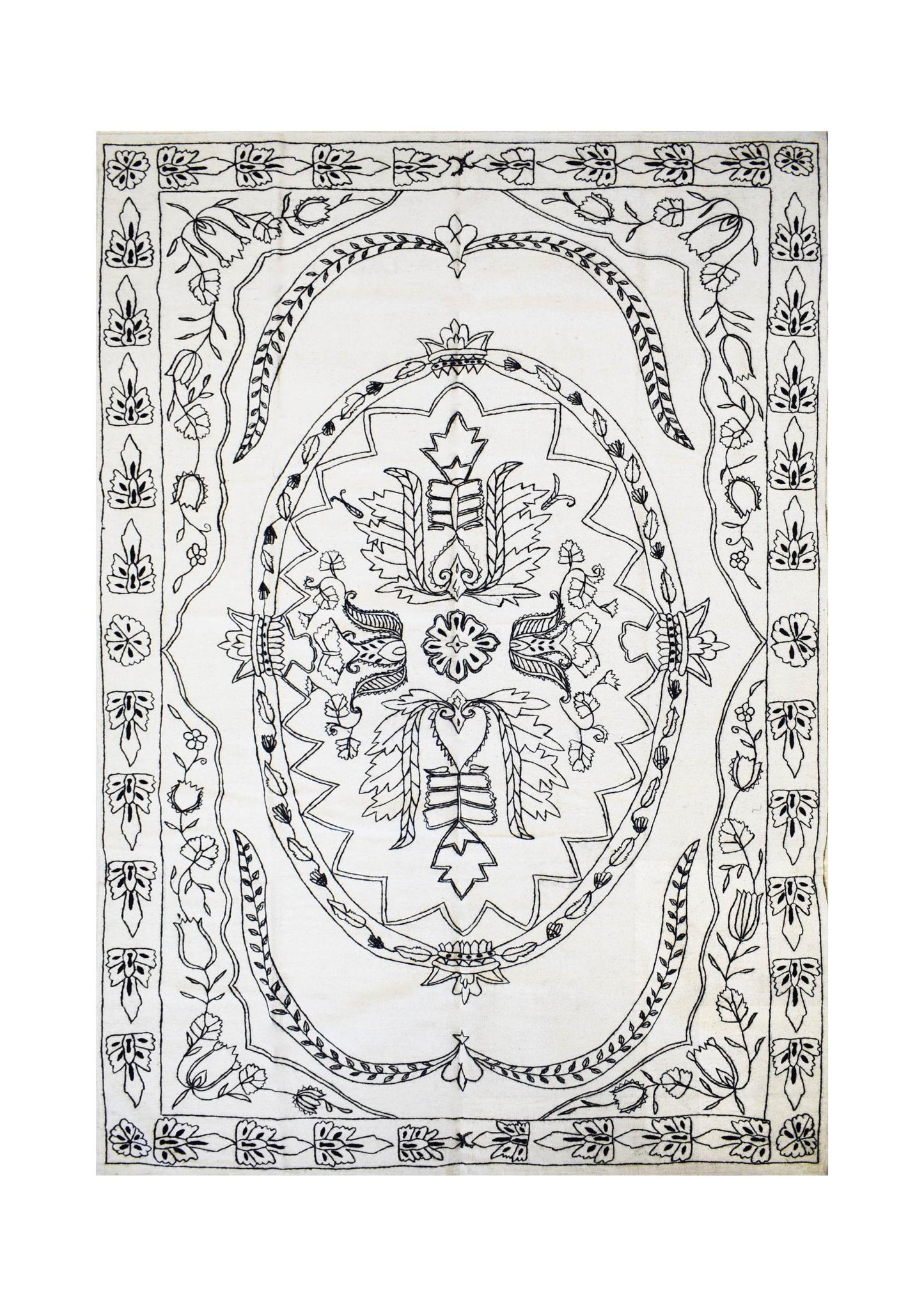 A rectangular white kilim rug featuring intricate black hand-embroidered floral patterns.