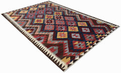 Handwoven Afghan Maimana kilim rug featuring a geometric pattern in vibrant multicolored wool.