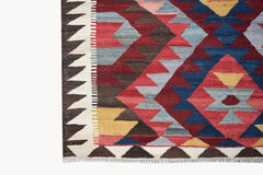 Handwoven Afghan Maimana kilim rug featuring a geometric pattern in red, blue, yellow, and brown.
