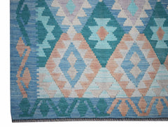 Handwoven Afghan Maimana kilim rug featuring a geometric diamond pattern in blue and peach tones.