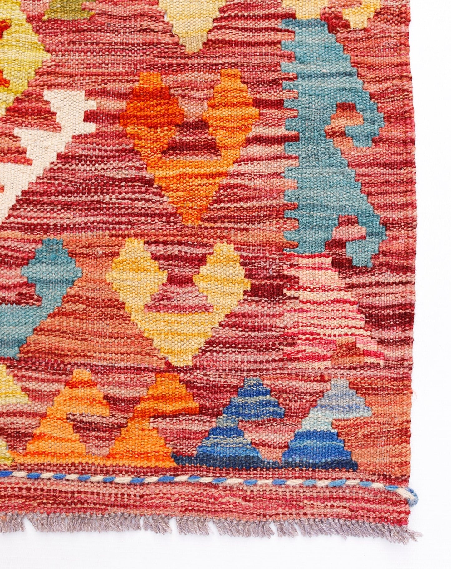 Handwoven Afghan Maimana kilim rug featuring a vibrant geometric pattern in wool.