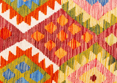 Handwoven Afghan Maimana kilim featuring a vibrant geometric pattern in wool.