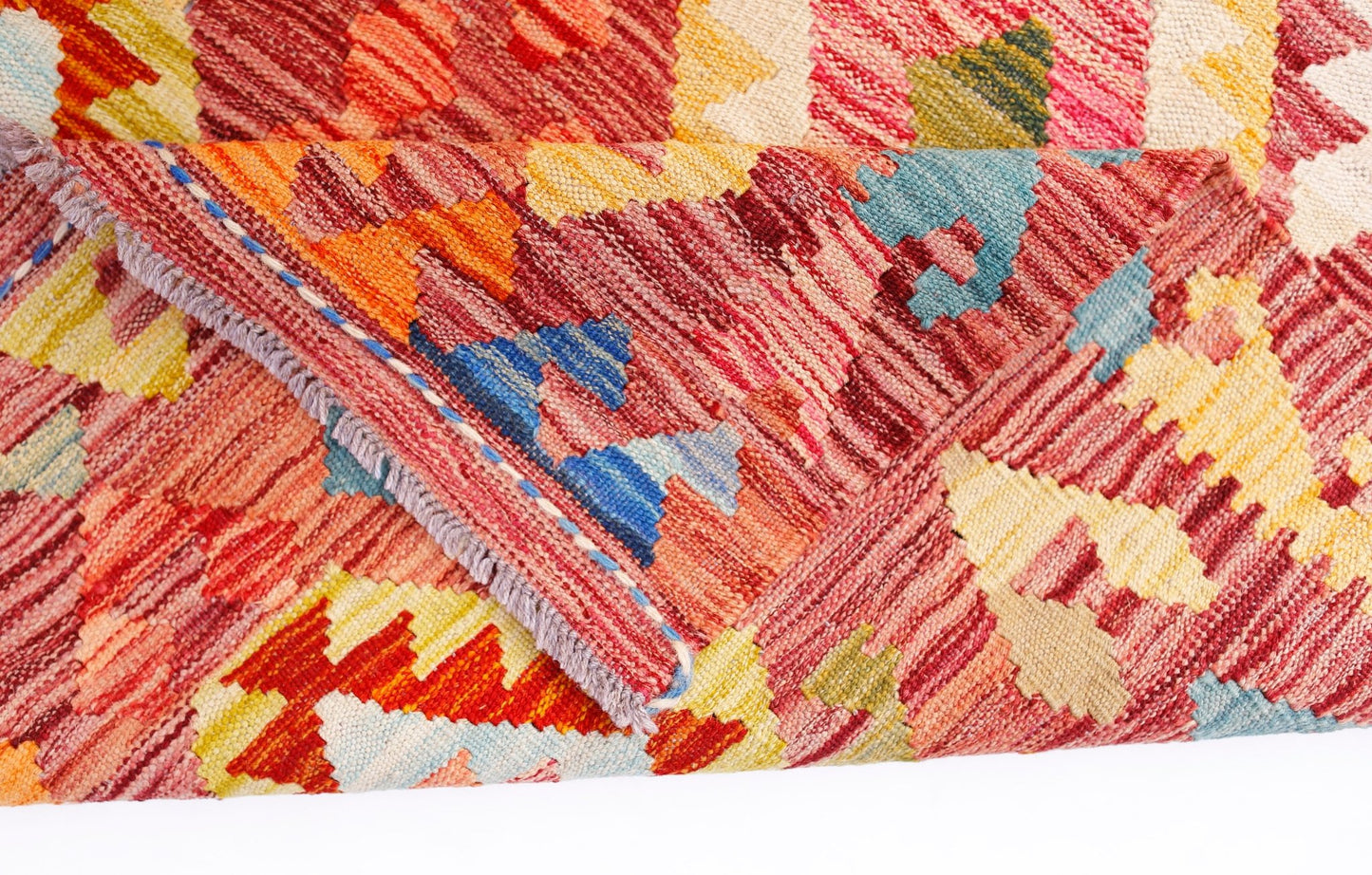 A handwoven Afghan Maimana kilim rug featuring a vibrant geometric pattern in wool.