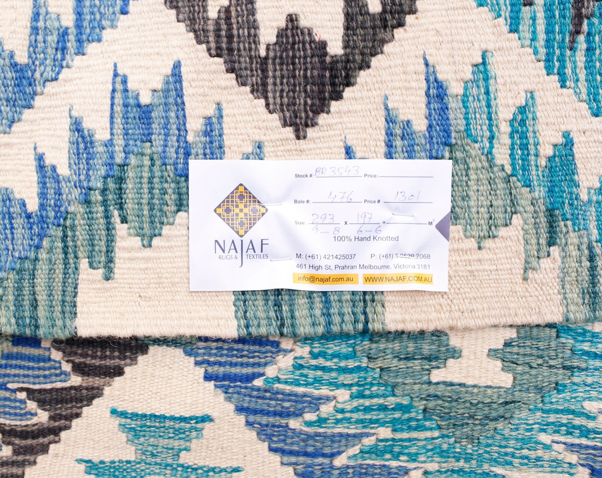 An Afghan Maimana kilim rug featuring a geometric pattern in shades of blue, grey, and cream.