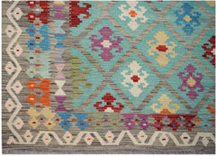 Handwoven Afghan Maimana kilim featuring a geometric diamond pattern in vibrant multicolored wool.