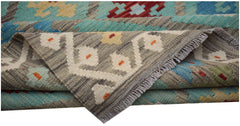 A handmade Afghan Maimana kilim rug featuring geometric patterns in blue, red, and grey wool.