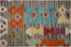 Handwoven Afghan Maimana kilim featuring a flat-weave texture and colorful geometric patterns.