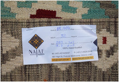 A handwoven Afghan Maimana kilim featuring a geometric pattern in teal, red, and neutral tones.