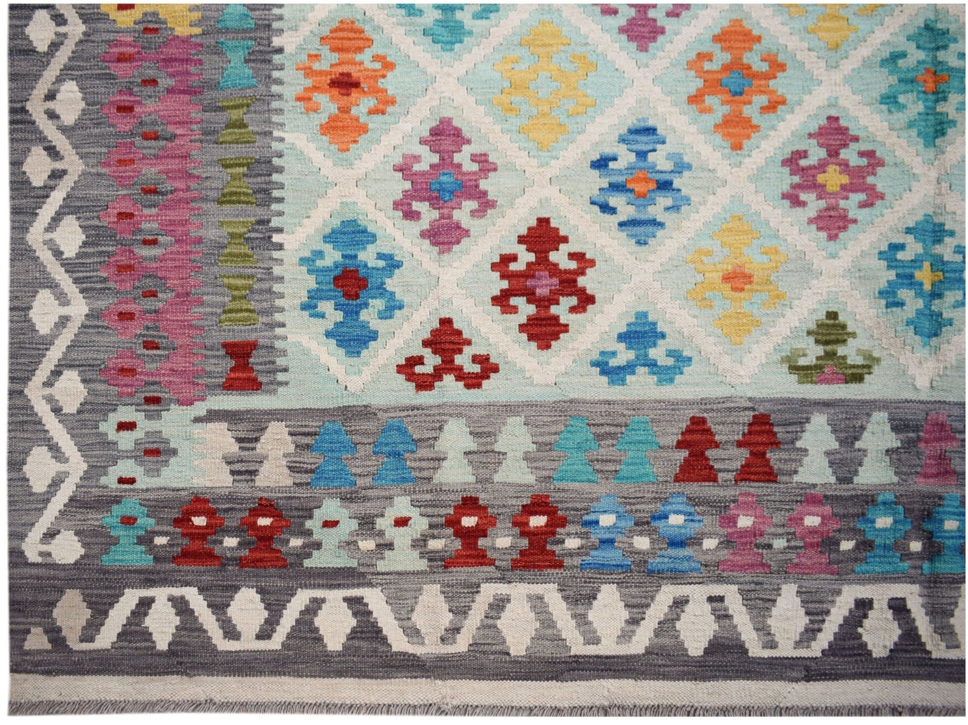Handwoven Afghan Maimana kilim featuring a geometric diamond pattern in vibrant multicolored wool.