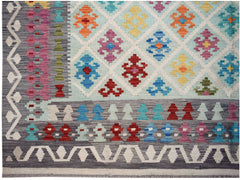 Handwoven Afghan Maimana kilim featuring a geometric diamond pattern in vibrant multicolored wool.