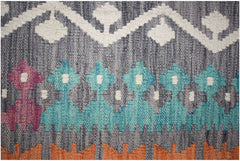 Handwoven Afghan Maimana kilim rug featuring geometric patterns in blue, pink, and orange.
