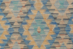 Handwoven Afghan Maimana kilim featuring a geometric diamond pattern in blue, tan, and grey tones.