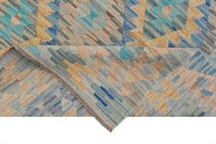 A handmade Afghan Maimana kilim rug featuring a geometric pattern in blue, beige, and tan tones.