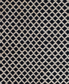 Handmade Afghan Maimana kilim rug featuring a repeating black and cream geometric pattern.