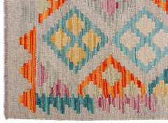 Handwoven Afghan Maimana kilim featuring a geometric pattern in vibrant orange, blue, and pink.