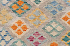 Handwoven Afghan Maimana kilim featuring a colorful geometric diamond pattern on a wool base.