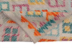 Handwoven Afghan Maimana kilim rug featuring a geometric pattern in vibrant multicolored wool.