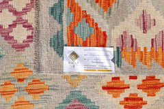 An Afghan Maimana Kilim rug featuring a geometric pattern in vibrant orange, teal, and magenta.