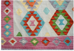 Handwoven Afghan Maimana kilim featuring a geometric diamond pattern in vibrant multicolored wool.