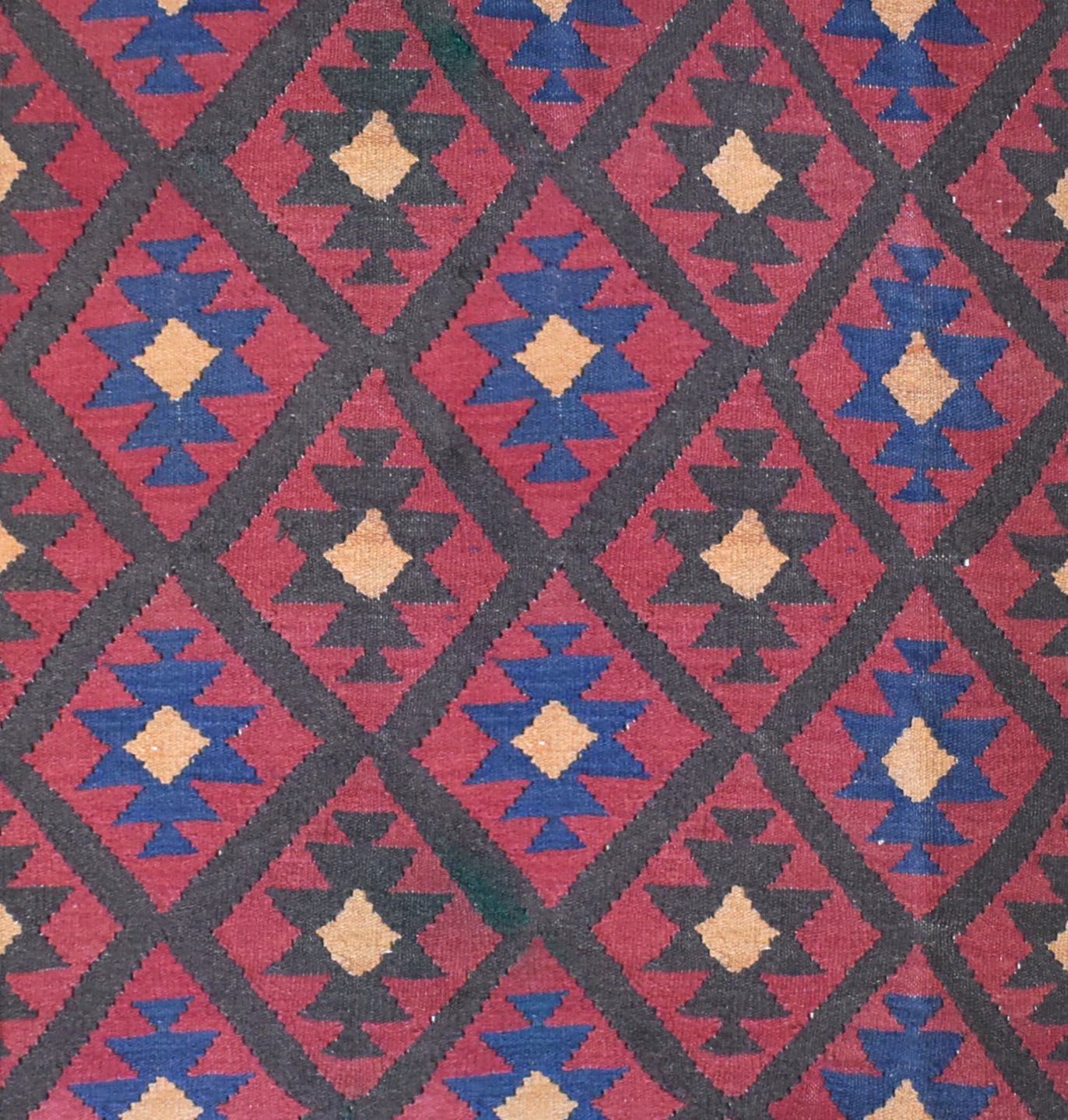 Handmade Afghan Maimana kilim rug featuring a repeating diamond pattern in red, blue, and tan.